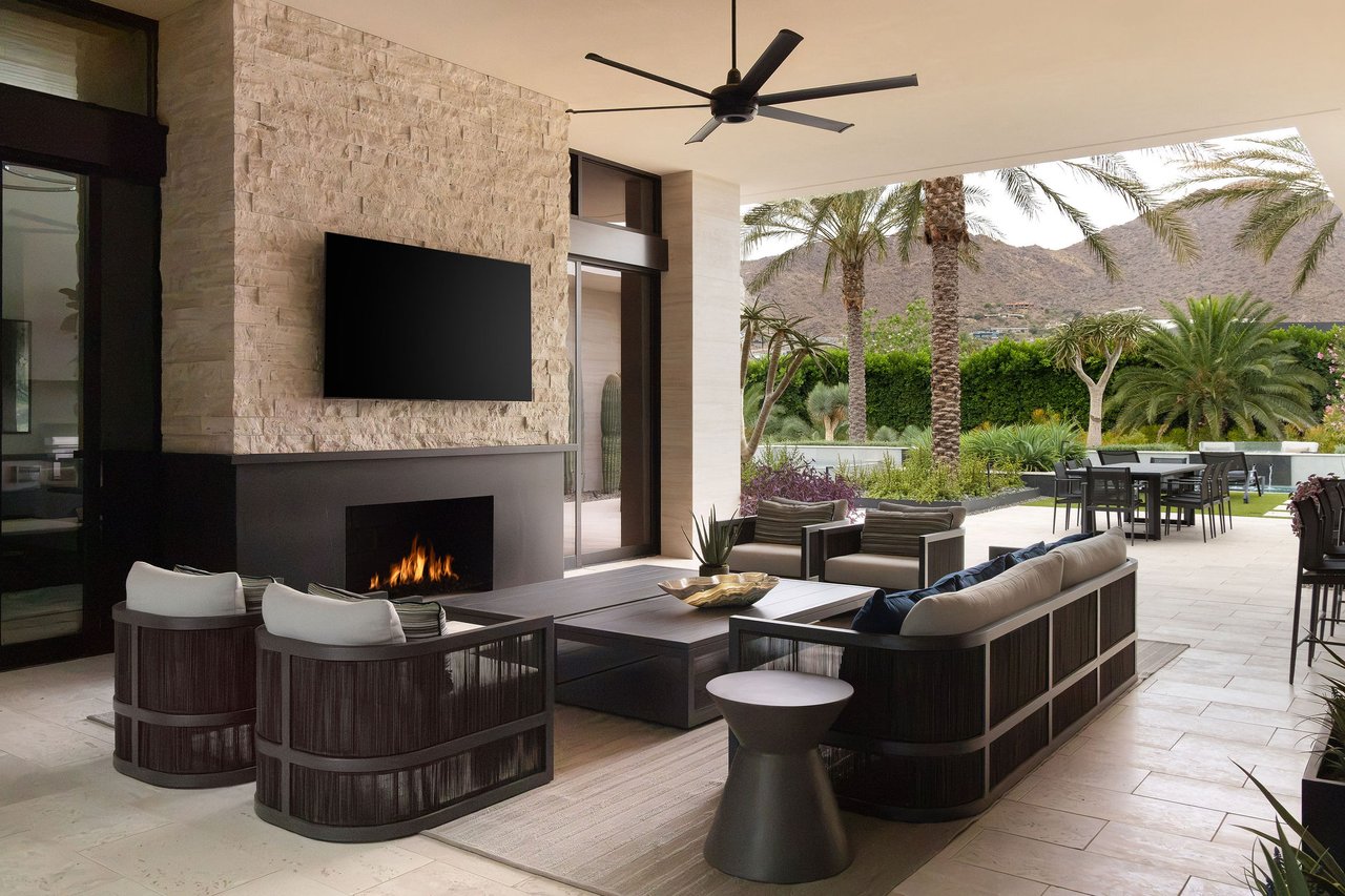 Modern luxury home in Paradise Valley with resort-style backyard, pool, fire feature, and contemporary architecture at sunset.