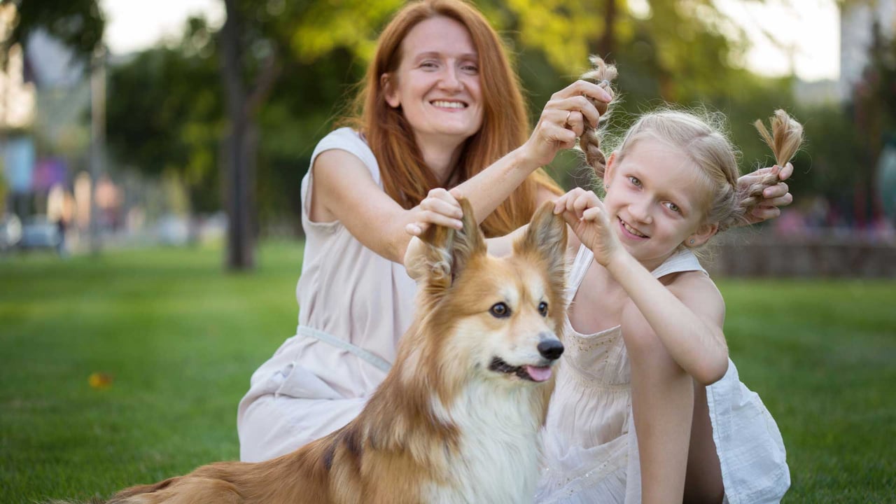 Mother and daughter with their dog outside their new Kiawah River home, embracing a slower, more connected Lowcountry life.