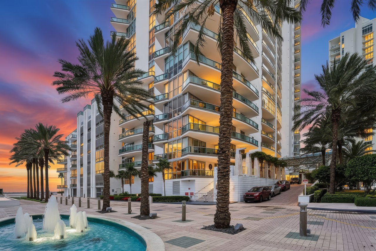 Digitally enhanced twilight exterior of Jade Residences at 1331 Brickell Bay Drive with palm-lined entrance and fountain