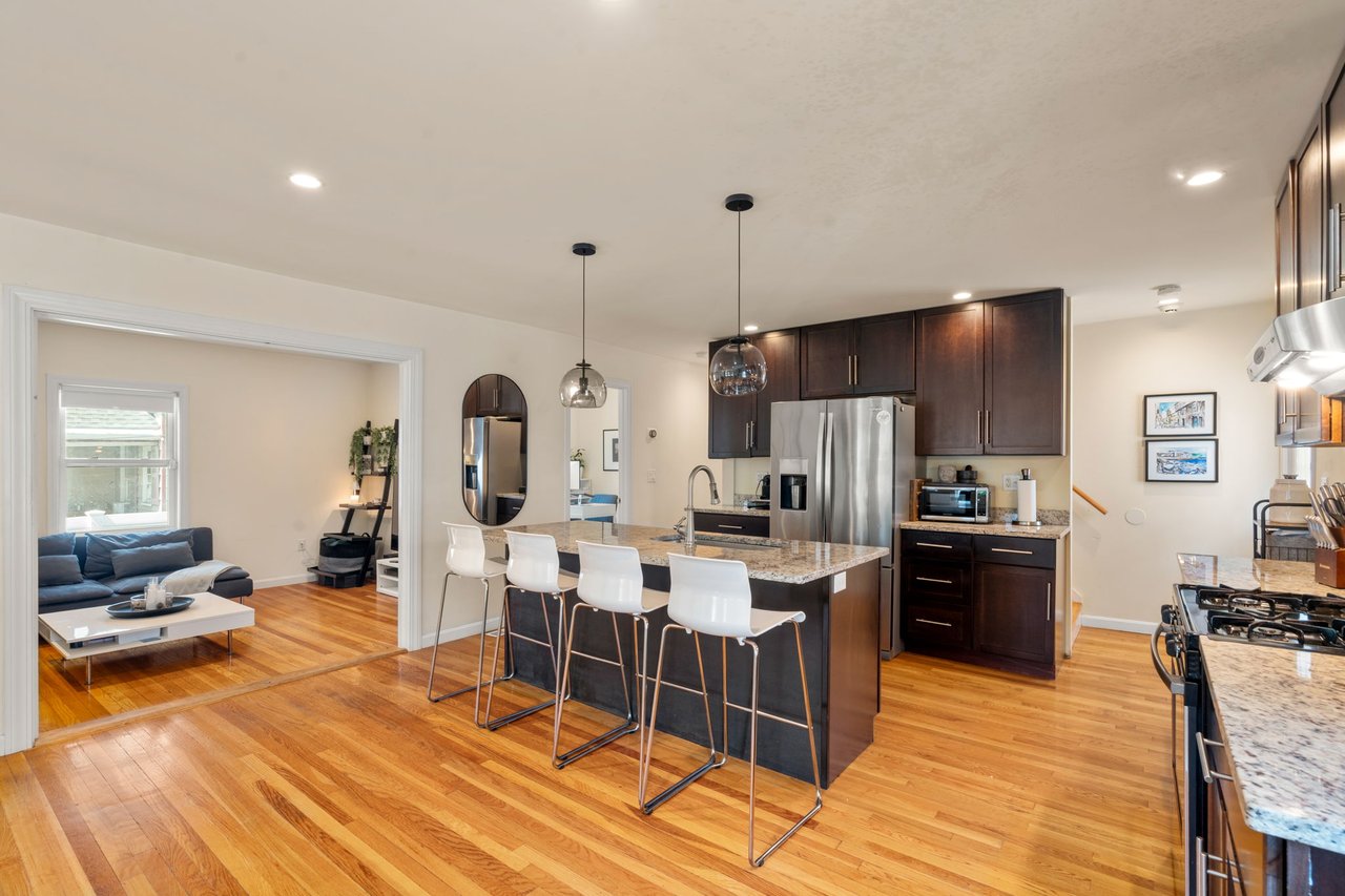 Bright kitchen at 60 French Street in North Quincy with cabinetry and center island