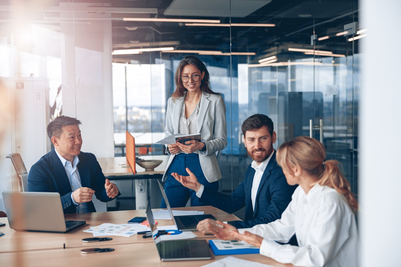 Team of real estate professionals collaborating in modern office setting.