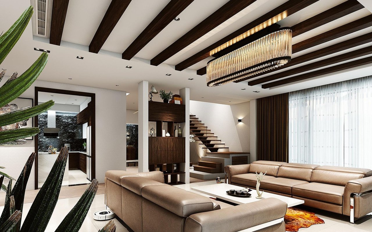 Modern living room with a tan leather sectional, exposed ceiling beams, and a floating staircase.