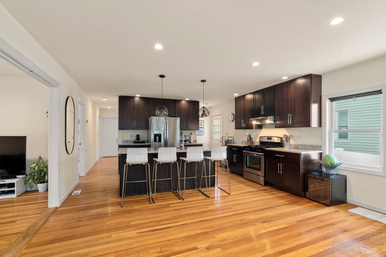 Bright kitchen at 60 French Street in North Quincy with cabinetry and center island