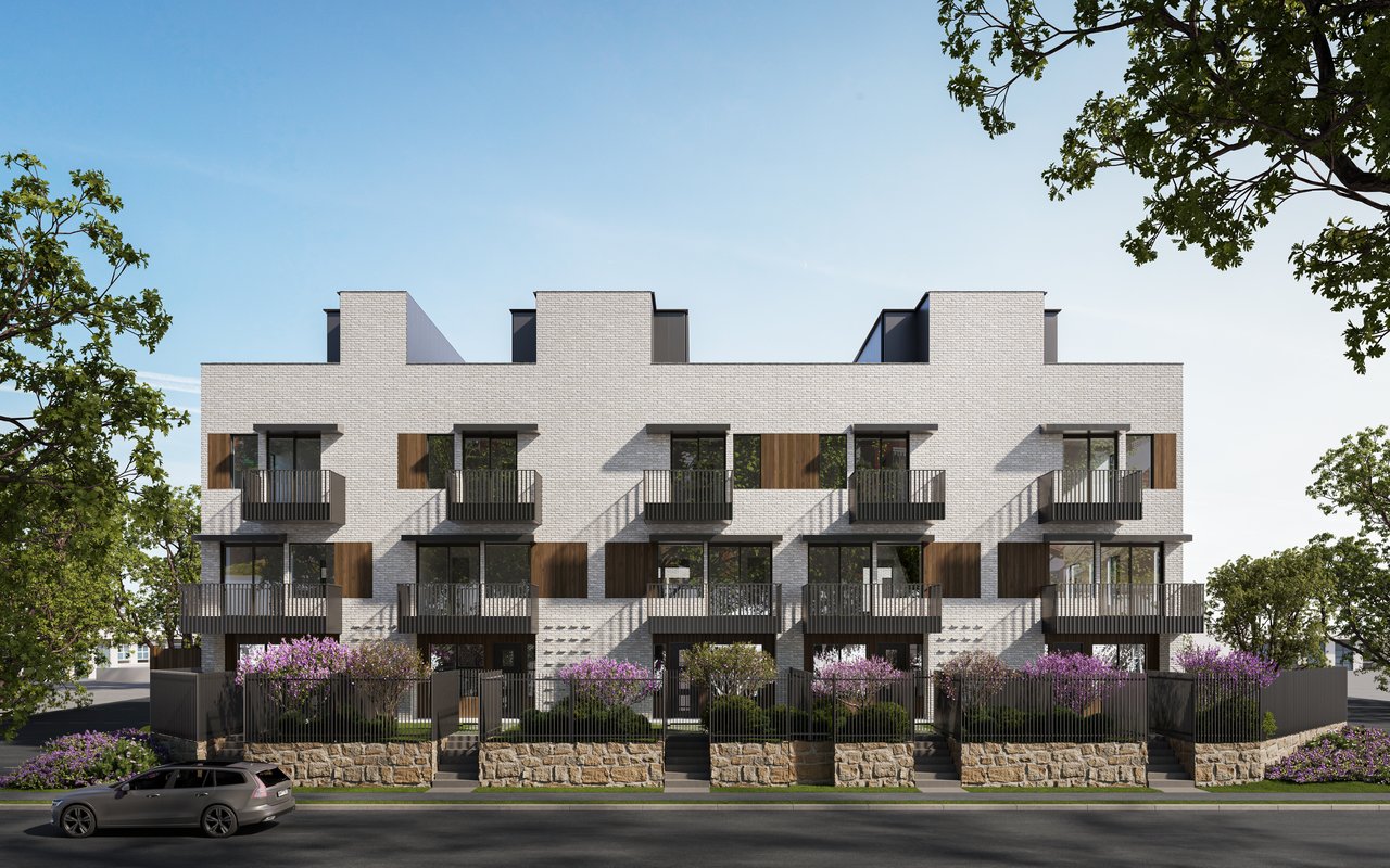 Oakborne I Turtle Creek condos with white brick, dark balconies, and landscaped frontage.