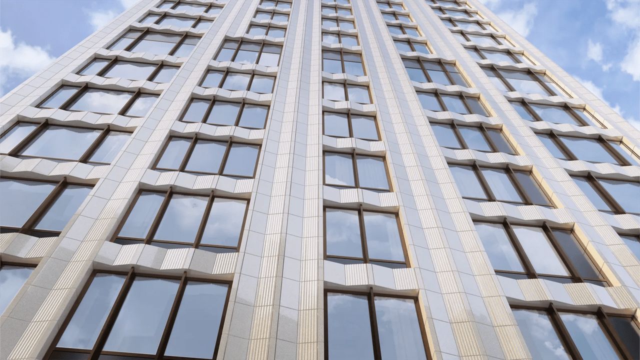 Modern high-rise facade with repeating windows and pale vertical columns against a cloudy sky.