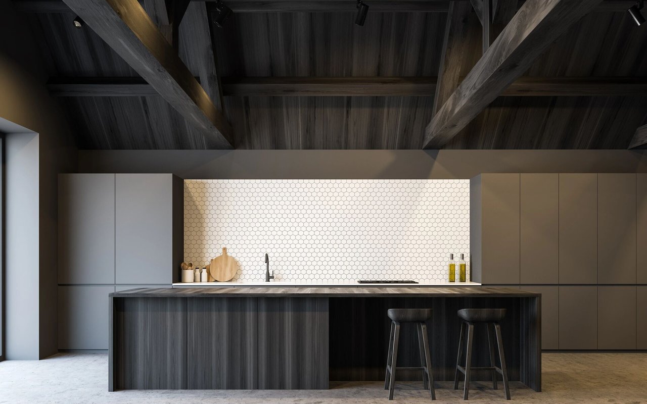 Modern kitchen with a dark wood island, two stools, hexagonal tile backsplash, and exposed timber ceiling beams.