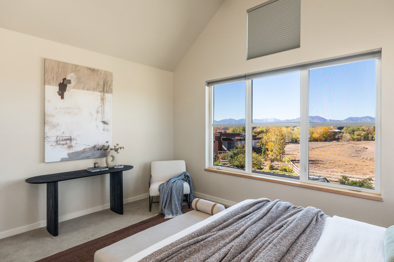 Primary bedroom sitting area with a console table and wide windows