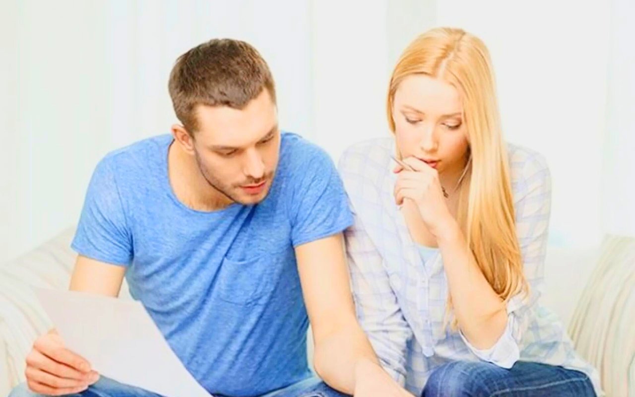 A couple reviews paperwork together while considering home financing.