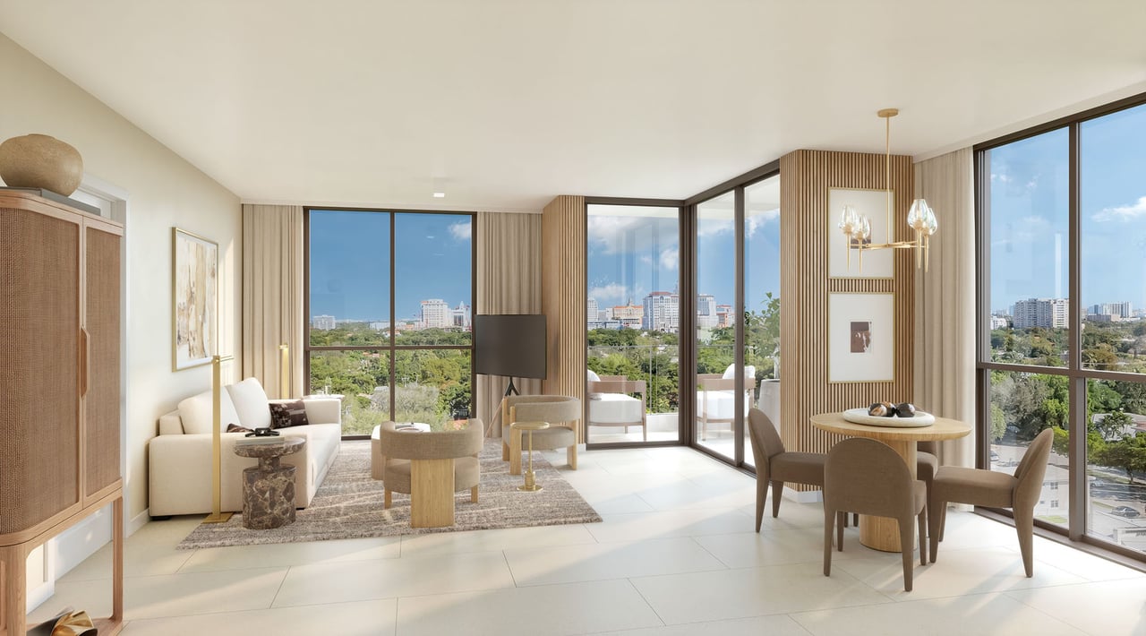 Furnished condo living and dining room with floor-to-ceiling windows overlooking Coral Gables.