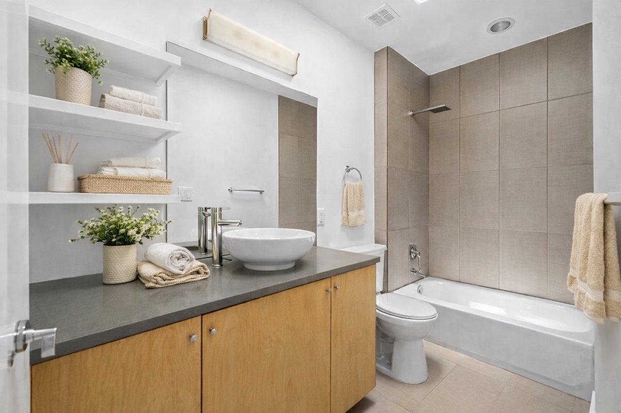 Second ensuite bathroom at 1302 S 5th St Unit A, Bouldin, Austin, TX, with a vessel sink, wood vanity, and tiled shower/tub surround.