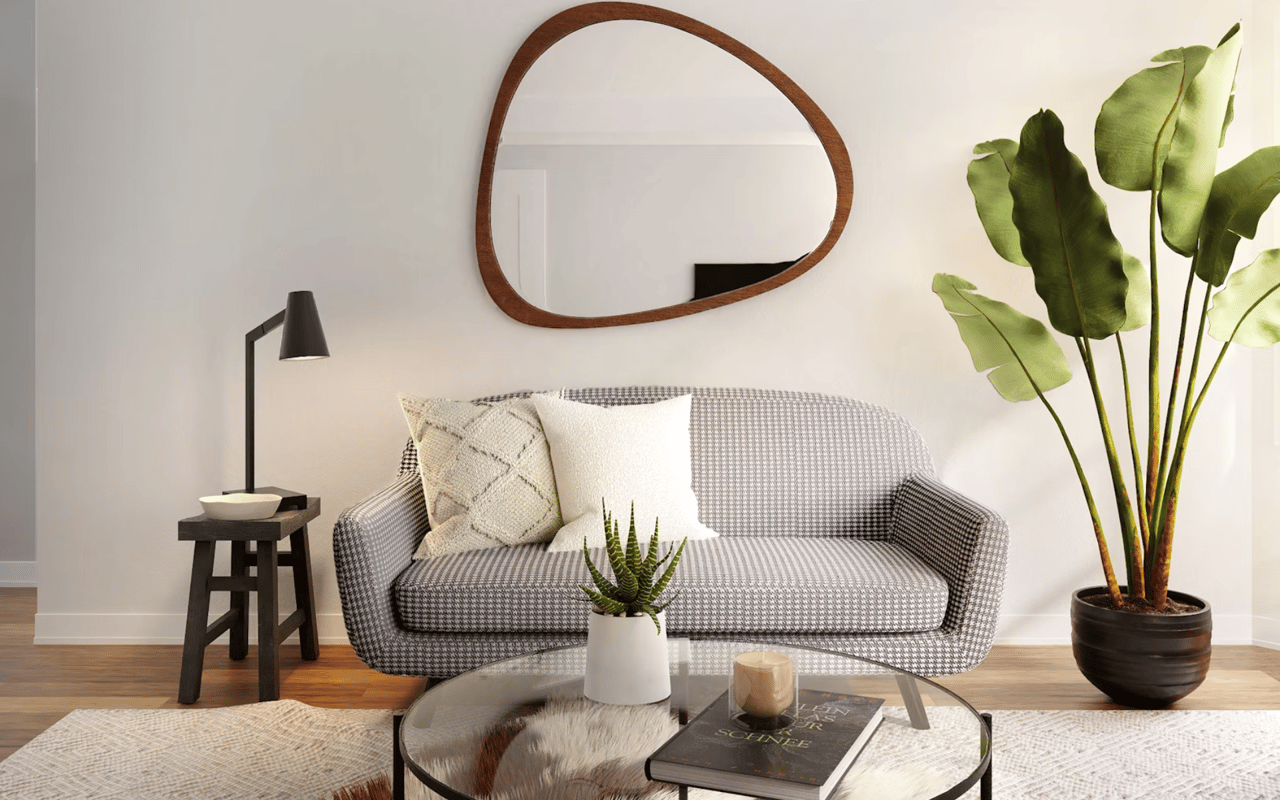  A contemporary living room featuring a cozy gray and white patterned sofa with two cream-colored throw pillows.