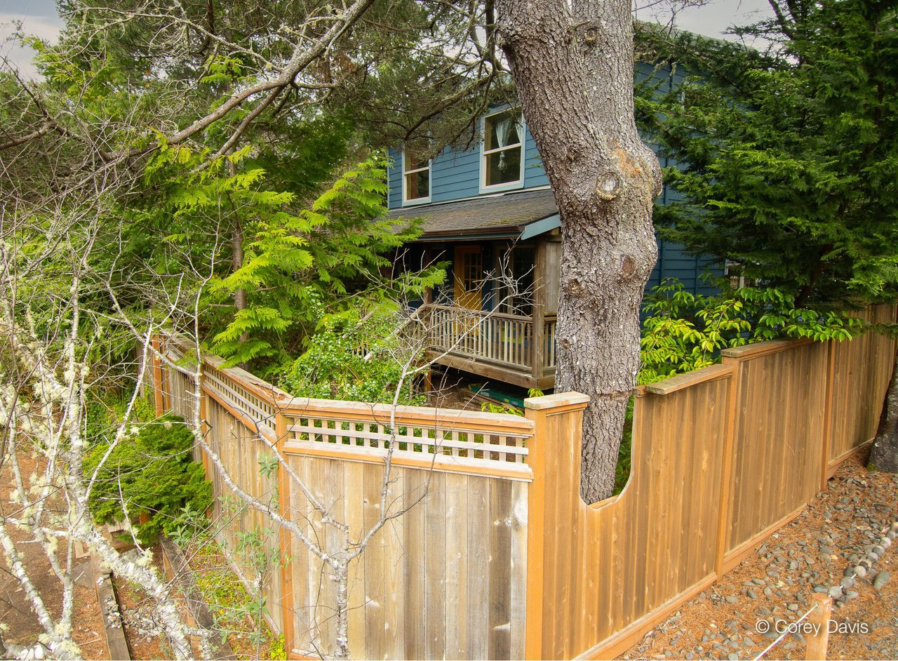 Sold Manzanita cottage at 463 Pine Ave represented by Meadow Davis of Home + Sea Realty with garden entry, porch swing, fenced yard, and walkable beach location