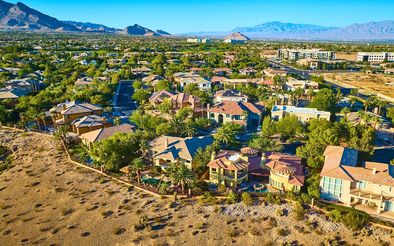 Spanish Springs homes and desert terrain with mountains in the distance.