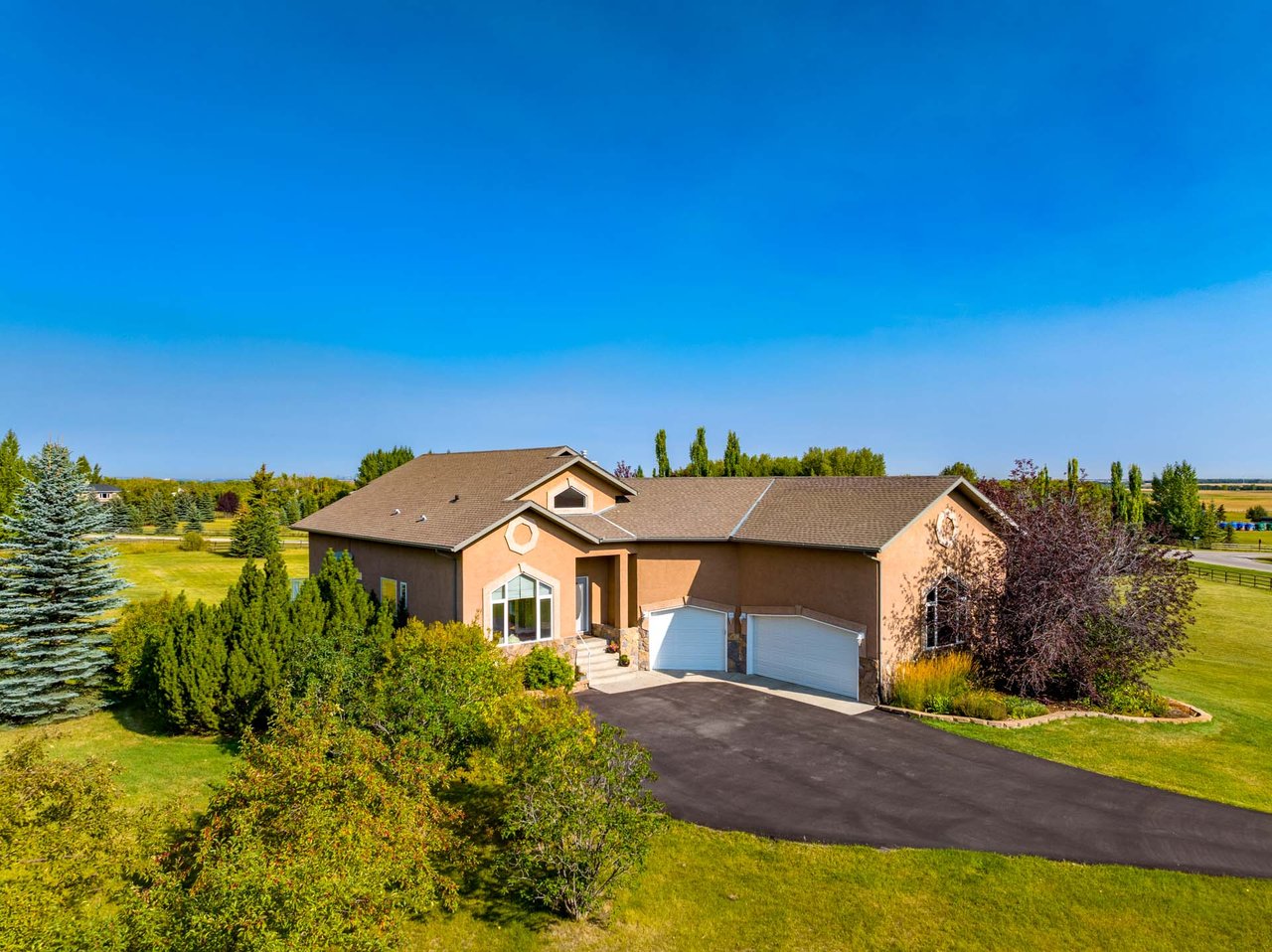 Refined Acreage Living Just Minutes from Okotoks | 4 Acres, Walkout Basement & Triple Garage