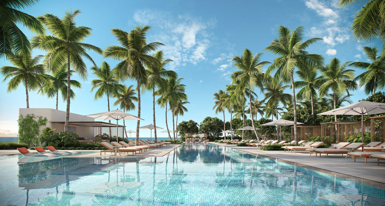 Resort pool lined with palm trees, sun loungers, and shaded seating areas.