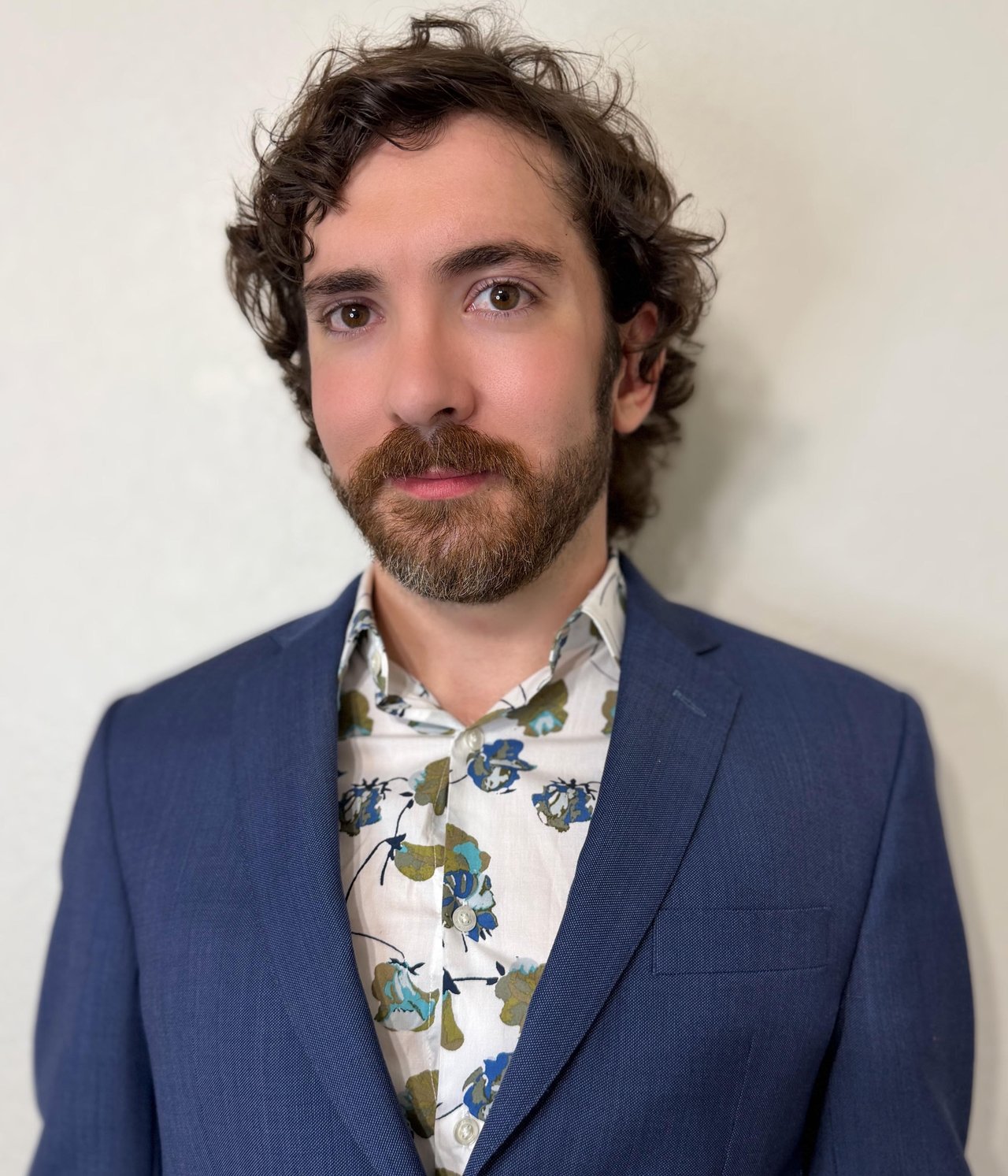 Nathan Smith in a navy blazer and floral shirt.