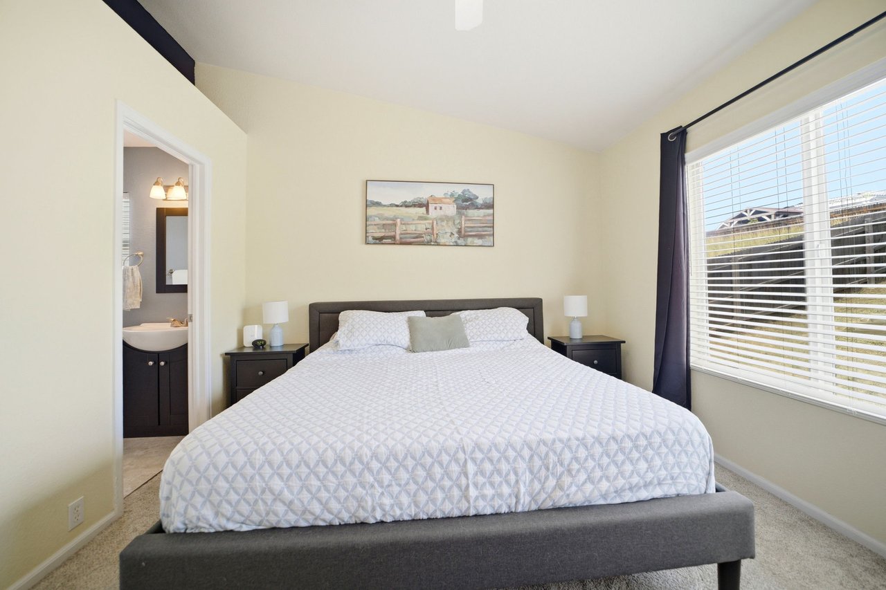 Primary Bedroom with vaulted ceilings, custom blinds and ensuite bath