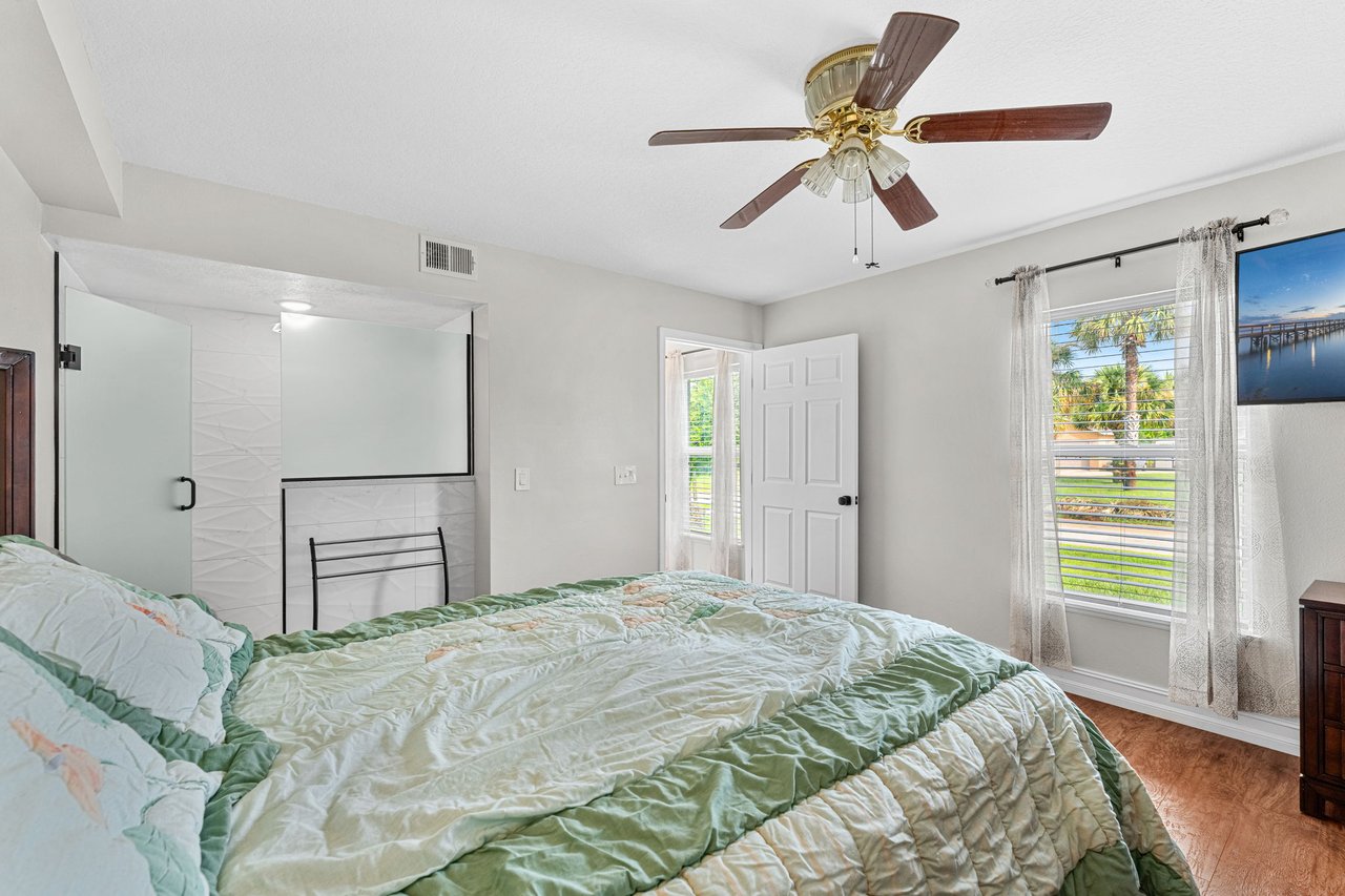 Bedroom with ceiling fan and natural light