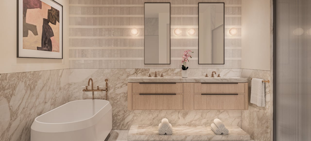 Bathroom with a freestanding tub, marble finishes, and a light wood double vanity.
