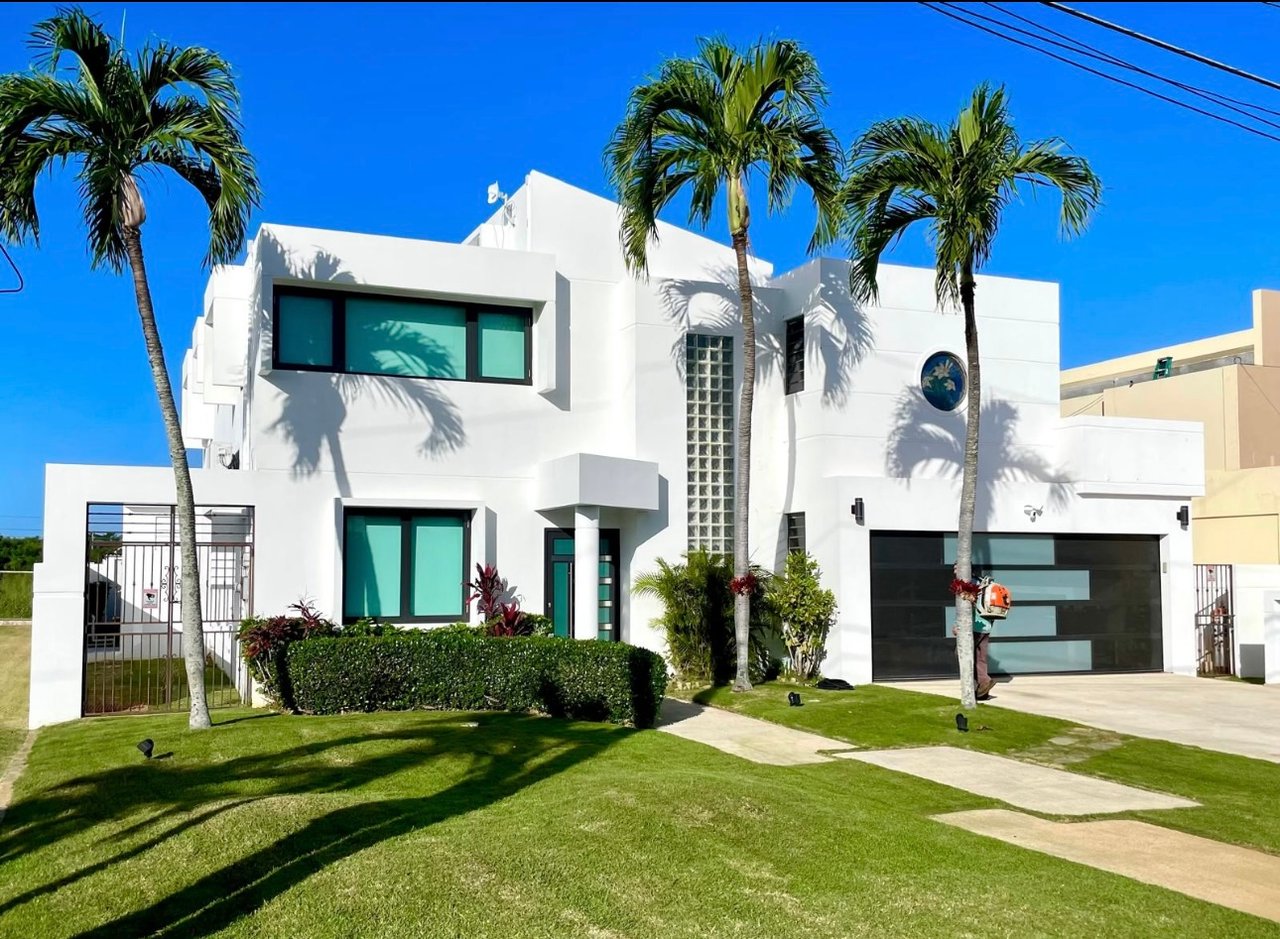 Modern white luxury house with palm trees
