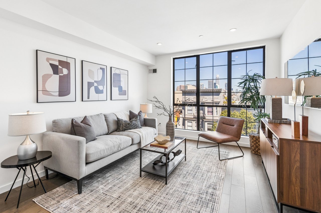 Bright, contemporary living space featuring wide-plank hardwood floors, oversized windows, and seamless indoor-outdoor visual flow—designed to maximize natural light and showcase iconic San Francisco views.