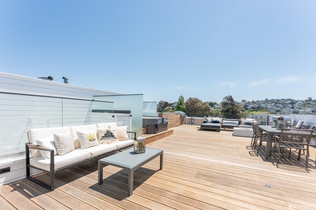 Rooftop terrace with lounge seating and panoramic neighborhood views
