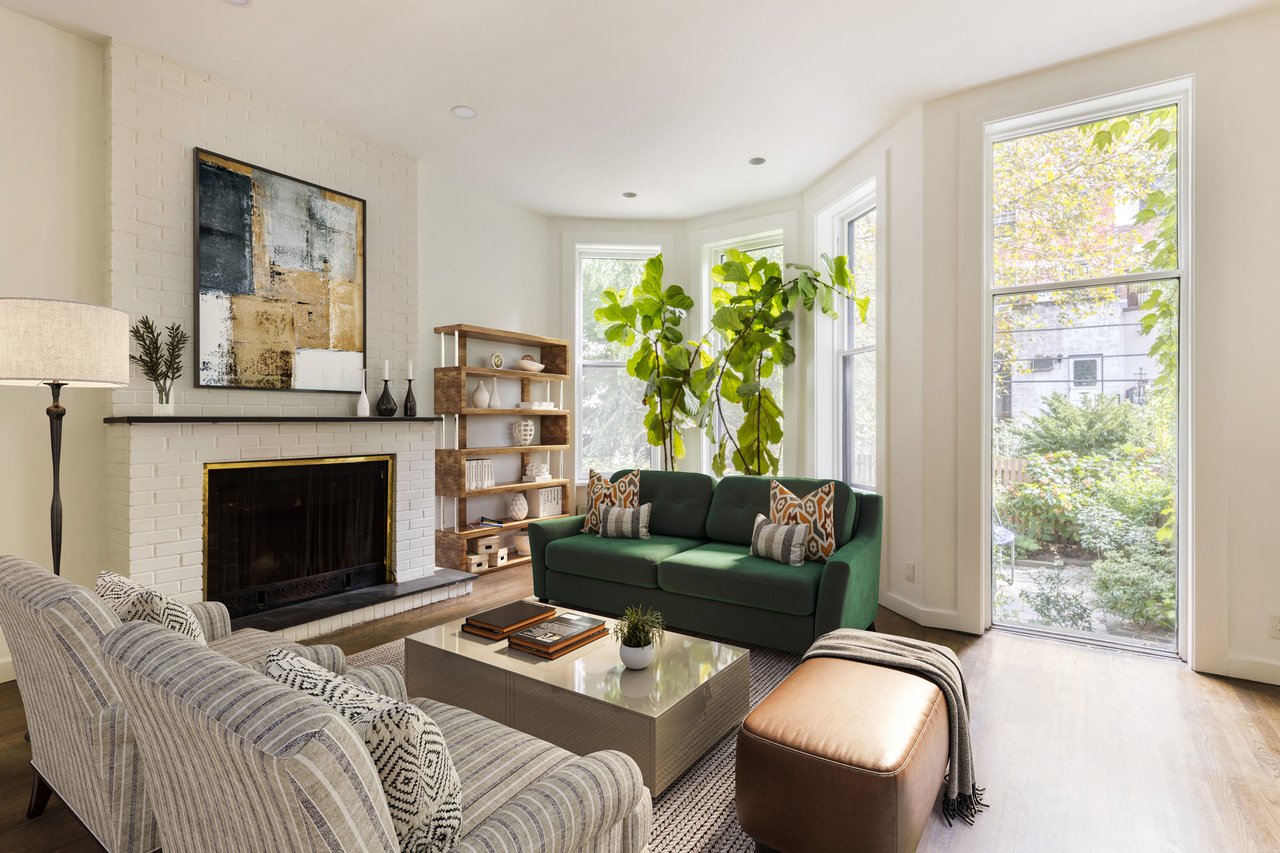 Symmetrical entrance of a beige stone building featuring double wooden doors under a rounded metal awning.