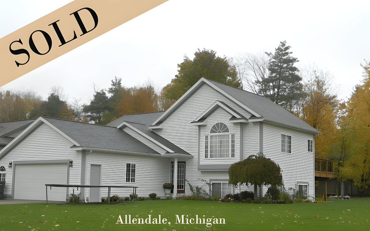 White two-story Allendale home with an attached garage and a prominent SOLD banner.