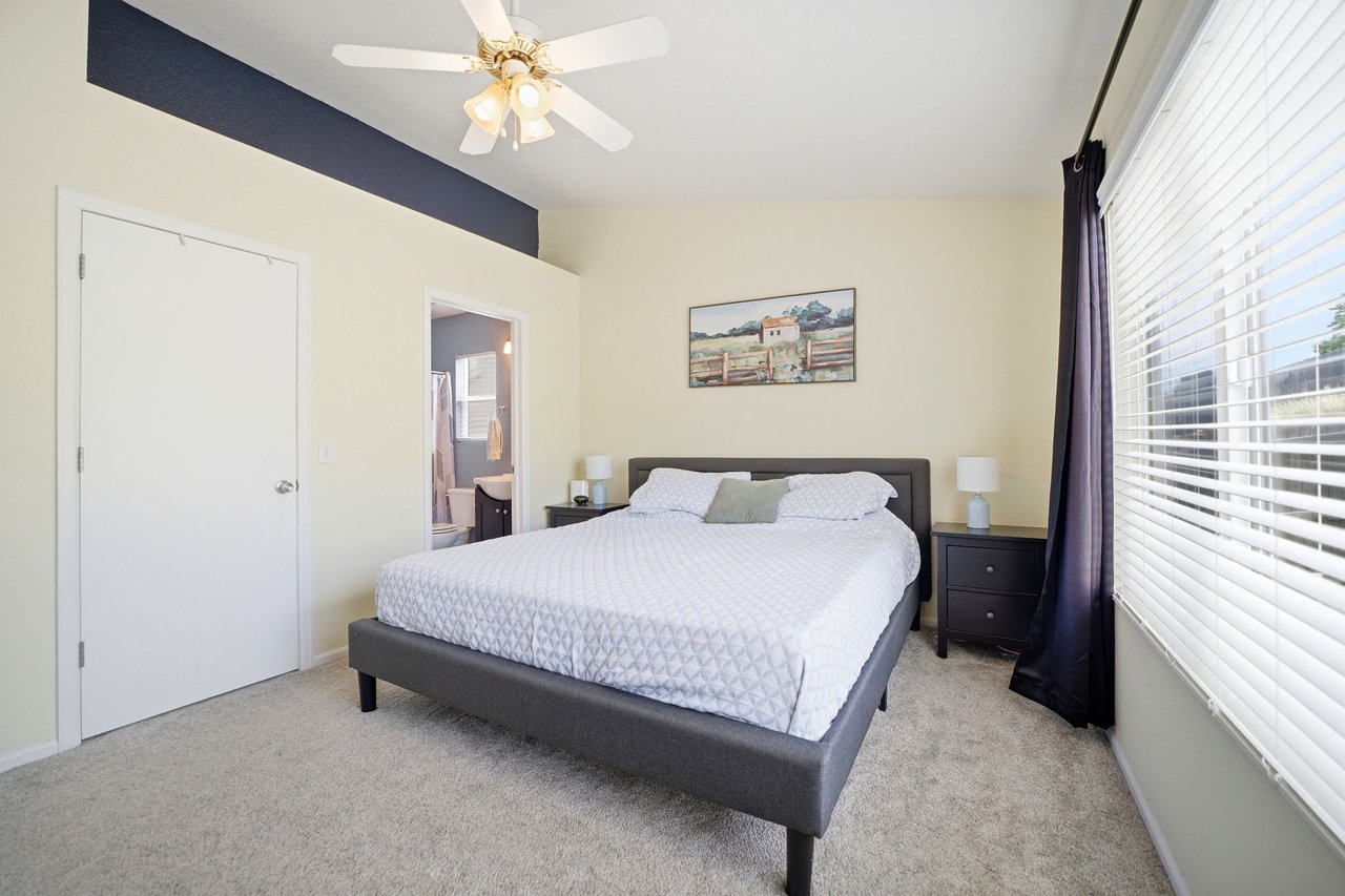 Primary Bedroom with vaulted ceilings and shelf area above