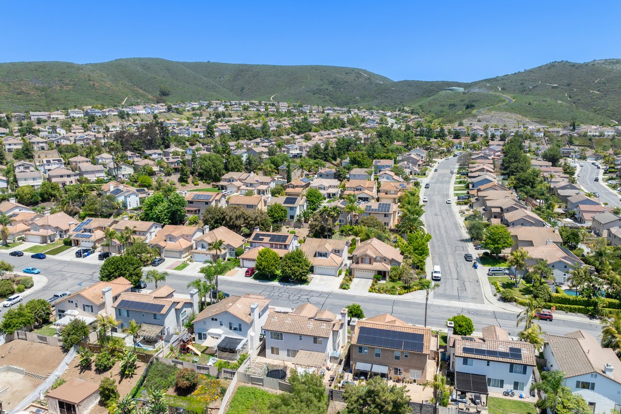 Aerial view of Hacienda Heights homes and streets beneath green hills.