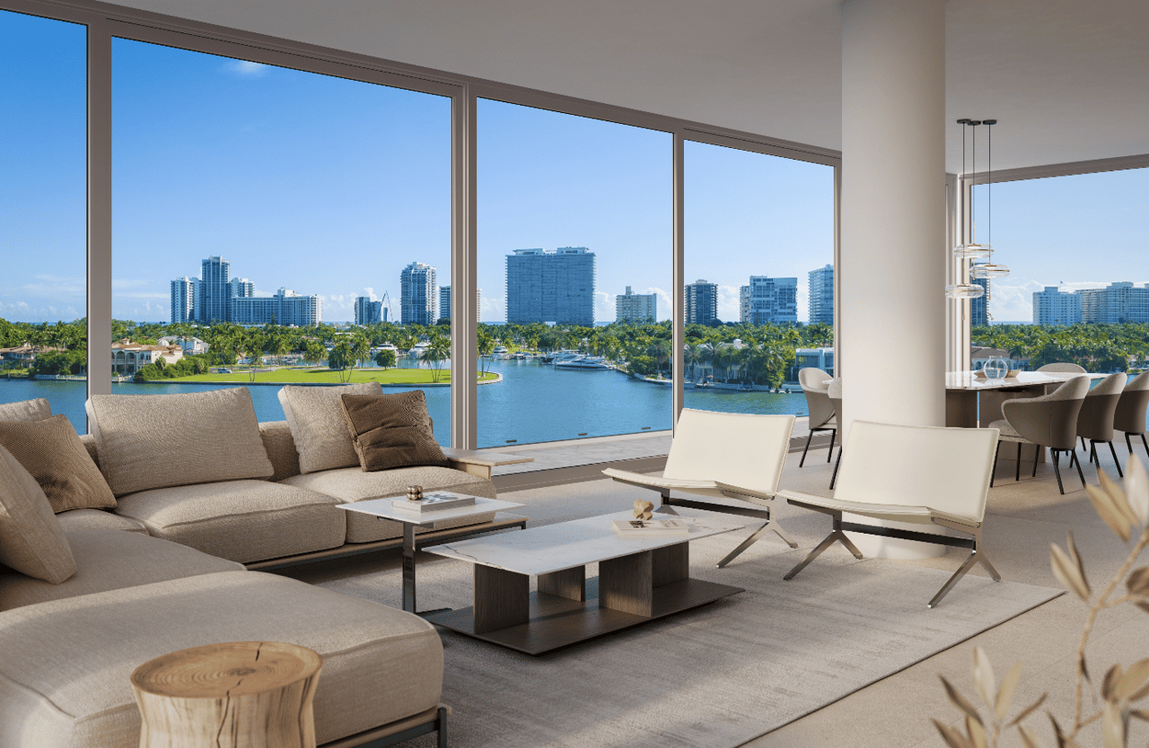 Furnished condo living room with floor-to-ceiling windows overlooking the bay and city skyline.