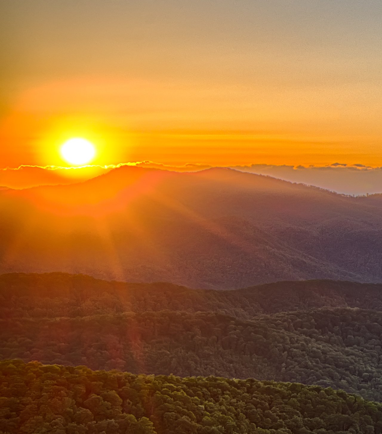 Bright sun descending over the mountains in Franklin, Nc