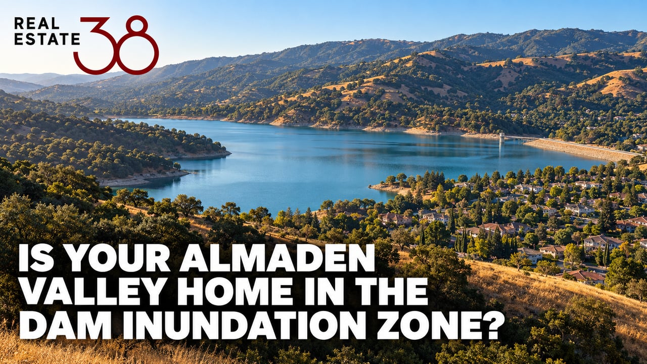 Almaden Reservoir and dam nestled in golden San Jose hillside above a distant neighborhood