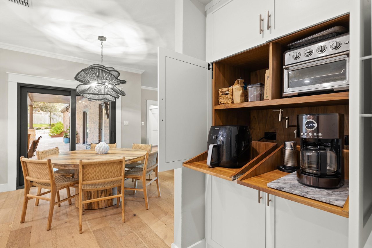 Appliance garage with pot filler and custom shelves