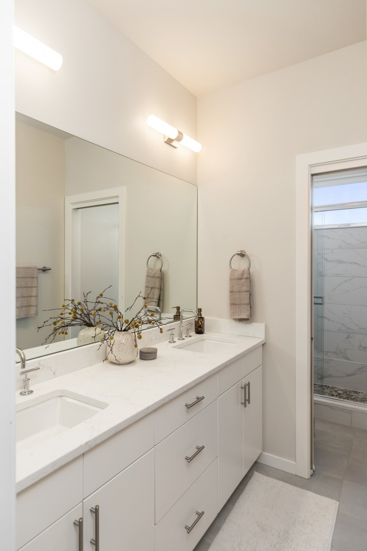 Hall bathroom with a double vanity and a separate shower room