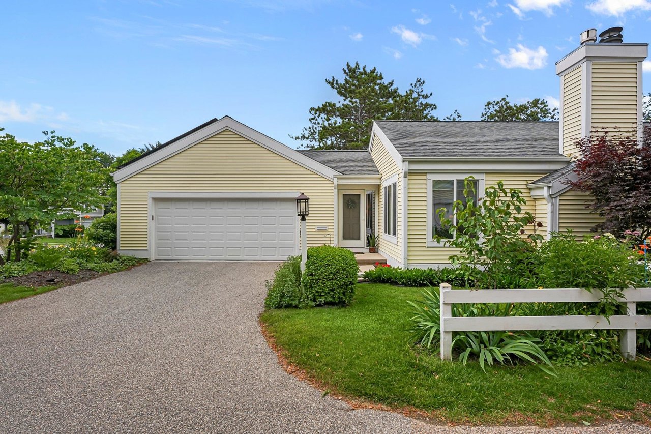 Exterior of a well-maintained Madison-area home with an attached garage and landscaped yard, illustrating the monthly expenses buyers should consider beyond the mortgage payment.