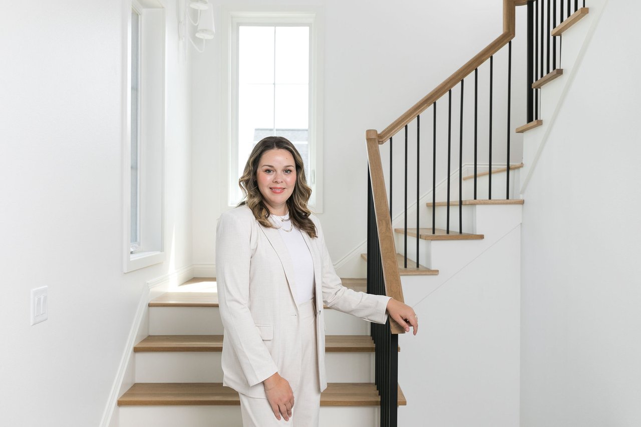 Cait Berry, Madison Wisconsin real estate agent with Insiders Realty, standing inside a modern luxury home while helping sellers prepare to list.