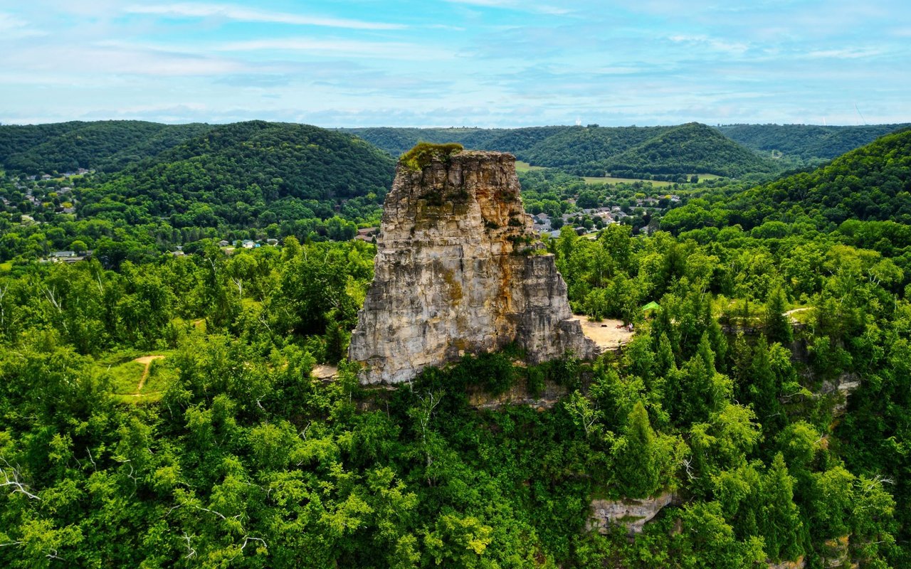 Aerial view of Winona County, Minnesota, showcasing rolling hills, lush forests, and the Mississippi River, reflecting the area's natural beauty and rural charm.
