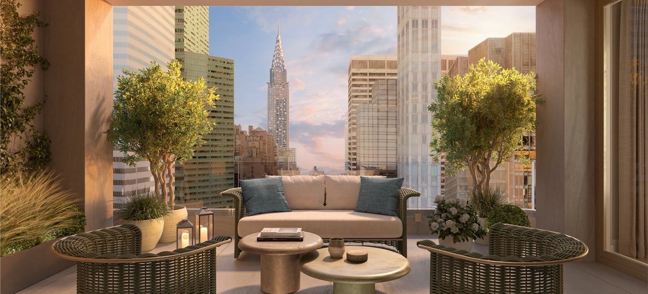 Furnished terrace with lounge seating and planters overlooking the Manhattan skyline and Chrysler Building.