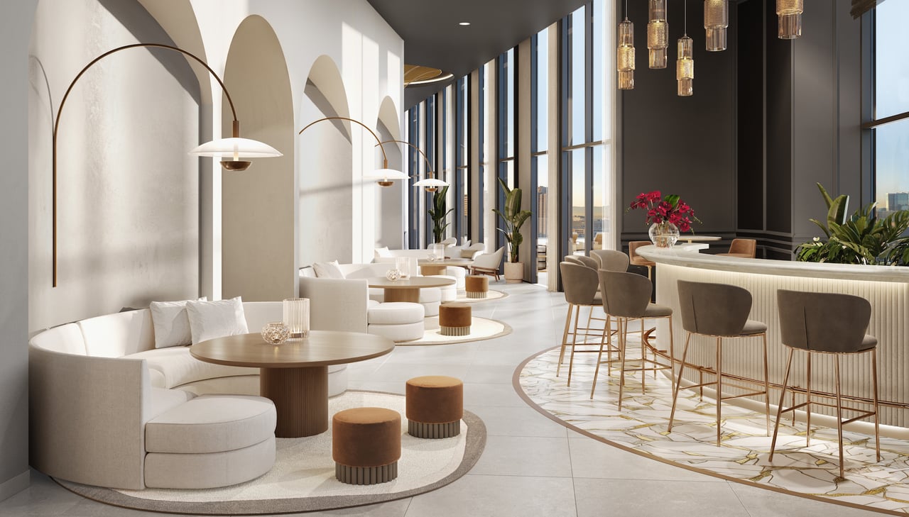 High-rise lounge with a curved white sectional, floor-to-ceiling windows, and a marble-front bar.