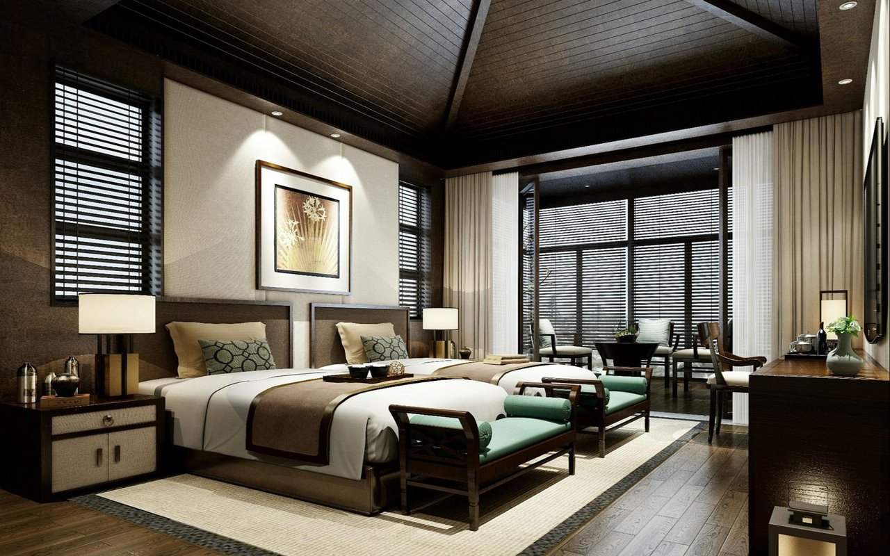 Furnished bedroom with two beds, a vaulted dark wood ceiling, and turquoise benches.