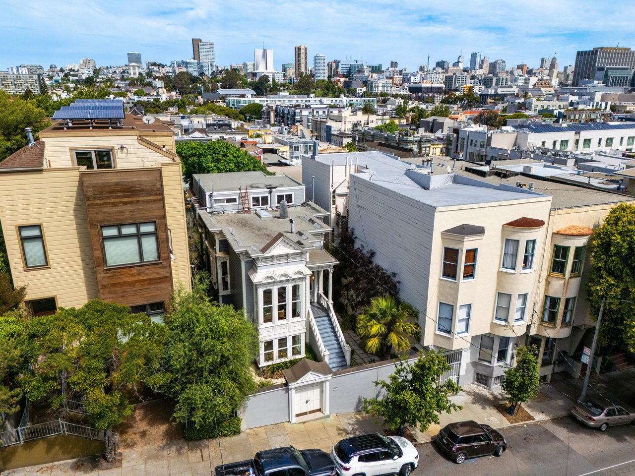 Aerial view looking down on a residential building, with the San Francisco skyline in the background
