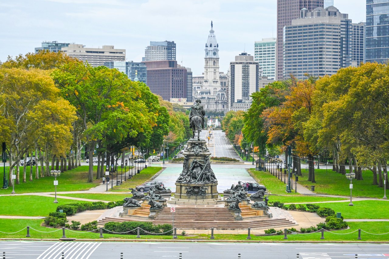Logan Square with the Swann Memorial Fountain, autumn trees, and Philadelphia City Hall in the distance.