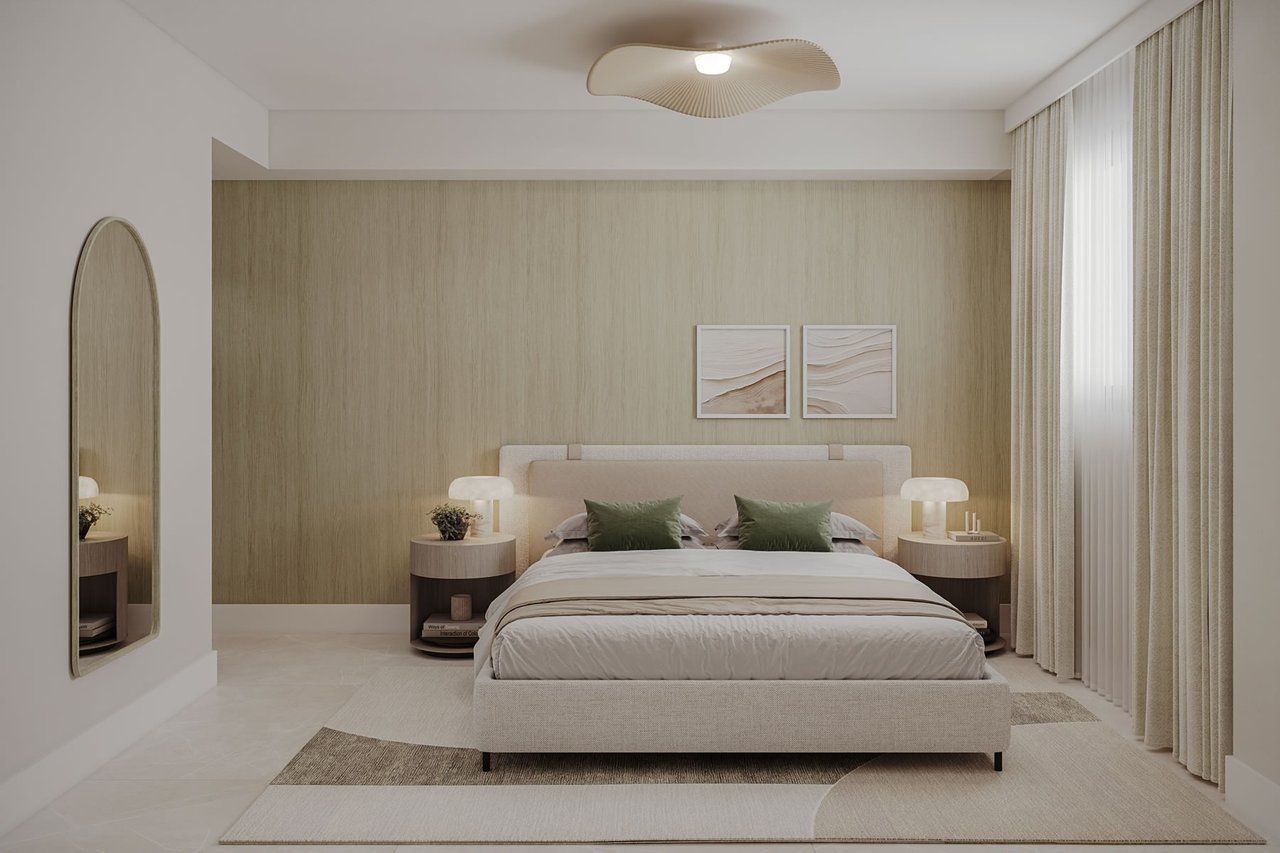 Staged bedroom with a centered upholstered bed, green pillows, textured beige wall, and full-height curtains.