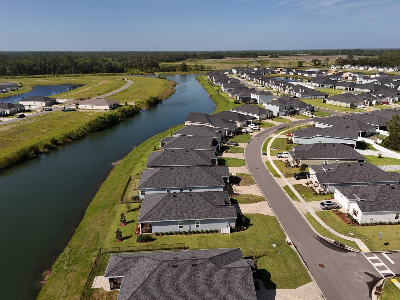 Aerial view of Silver Meadows homes beside a winding waterway.