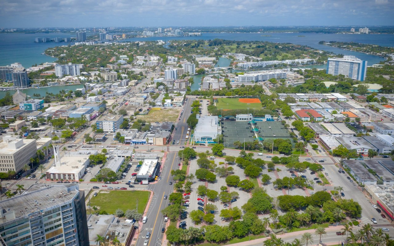 Aerial view of Fairview with urban streets, sports courts, and waterways in the distance.