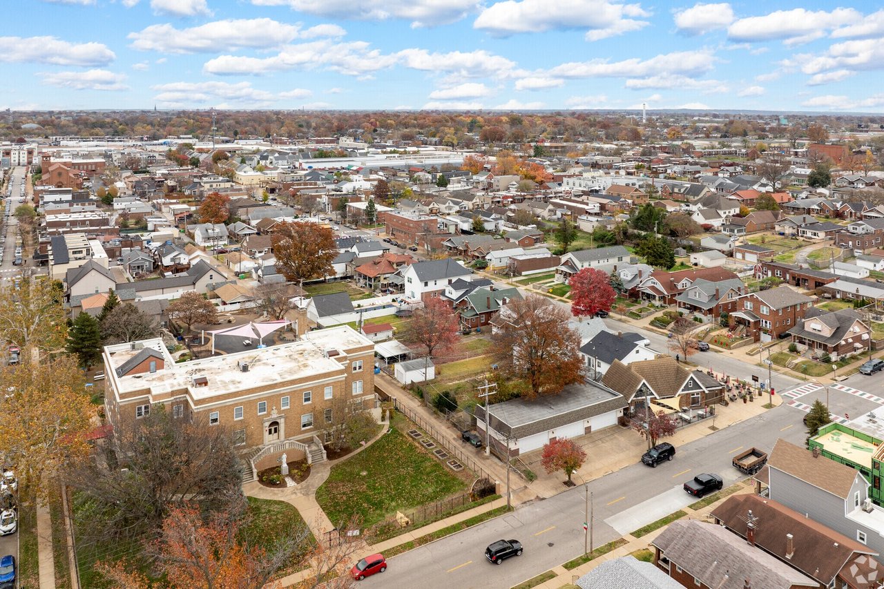 Aerial panorama of a residential neighborhood with autumn trees and streets.