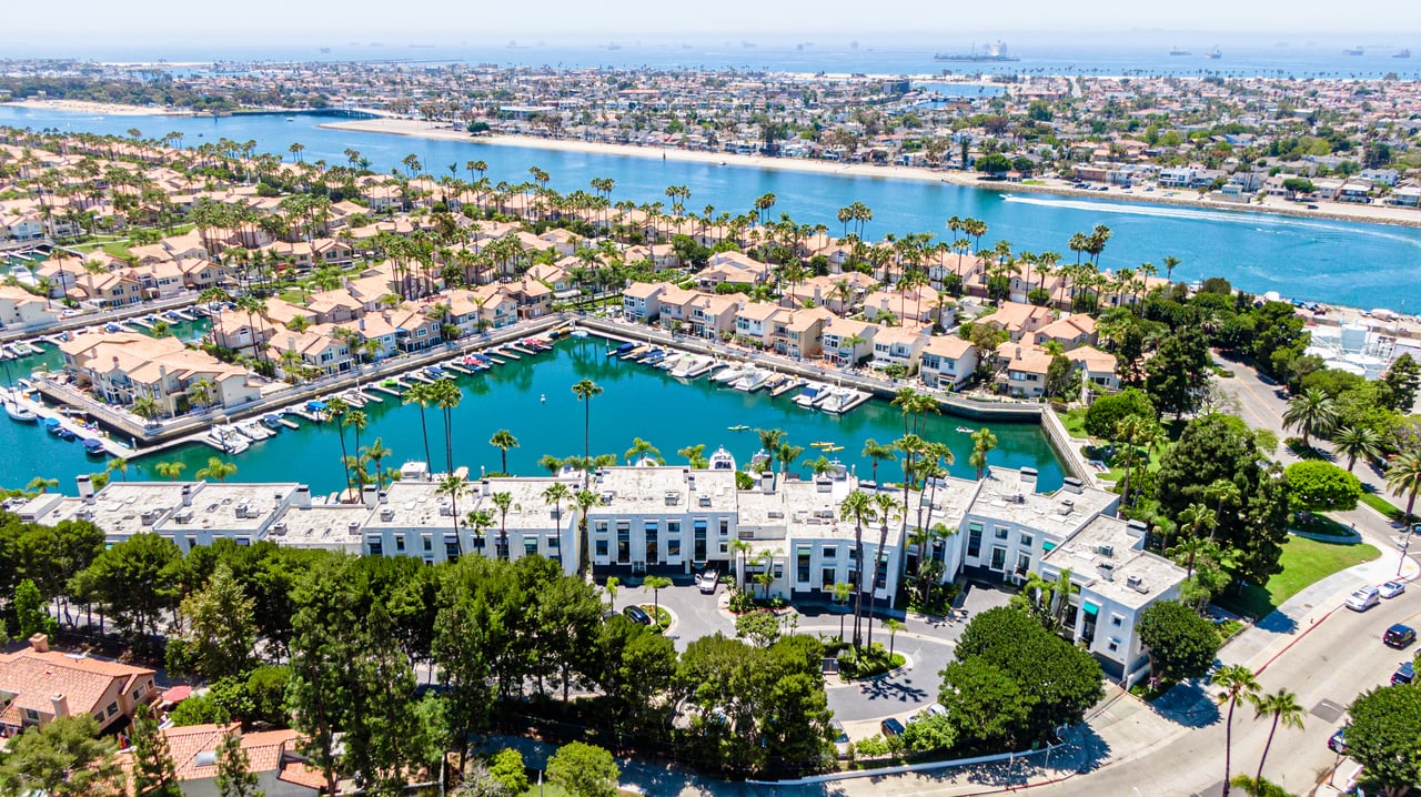 Aerial view of Spinnaker Coves townhomes along Alamitos Bay in Long Beach California with waterfront channels and coastal setting