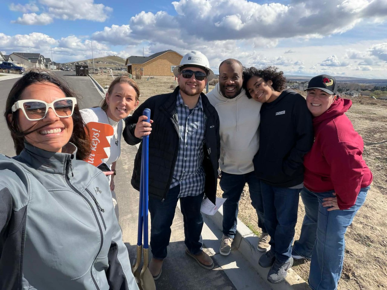 New homeowners standing in front of new construction lot in kennewick wa