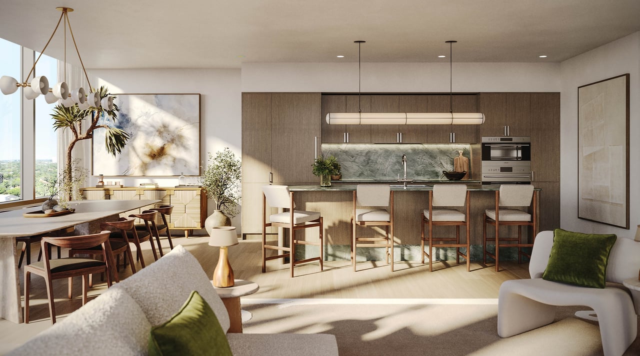 Open-plan kitchen and dining area with a marble backsplash, wood cabinetry, and a long island with bar stools.